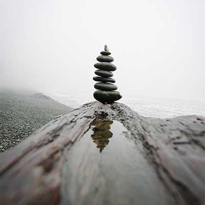 Stones stacked with mountain in view