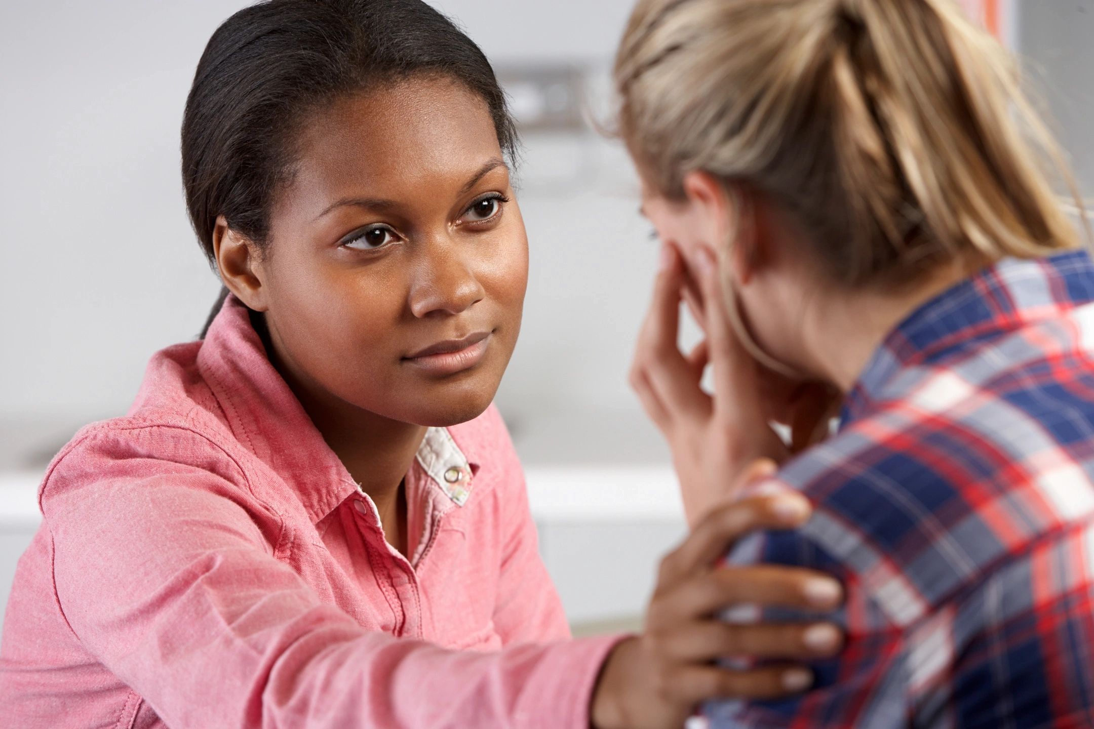 Two women talking together offering support